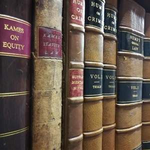 Angled view along shelf of leatherbound Scottish criminal law books.