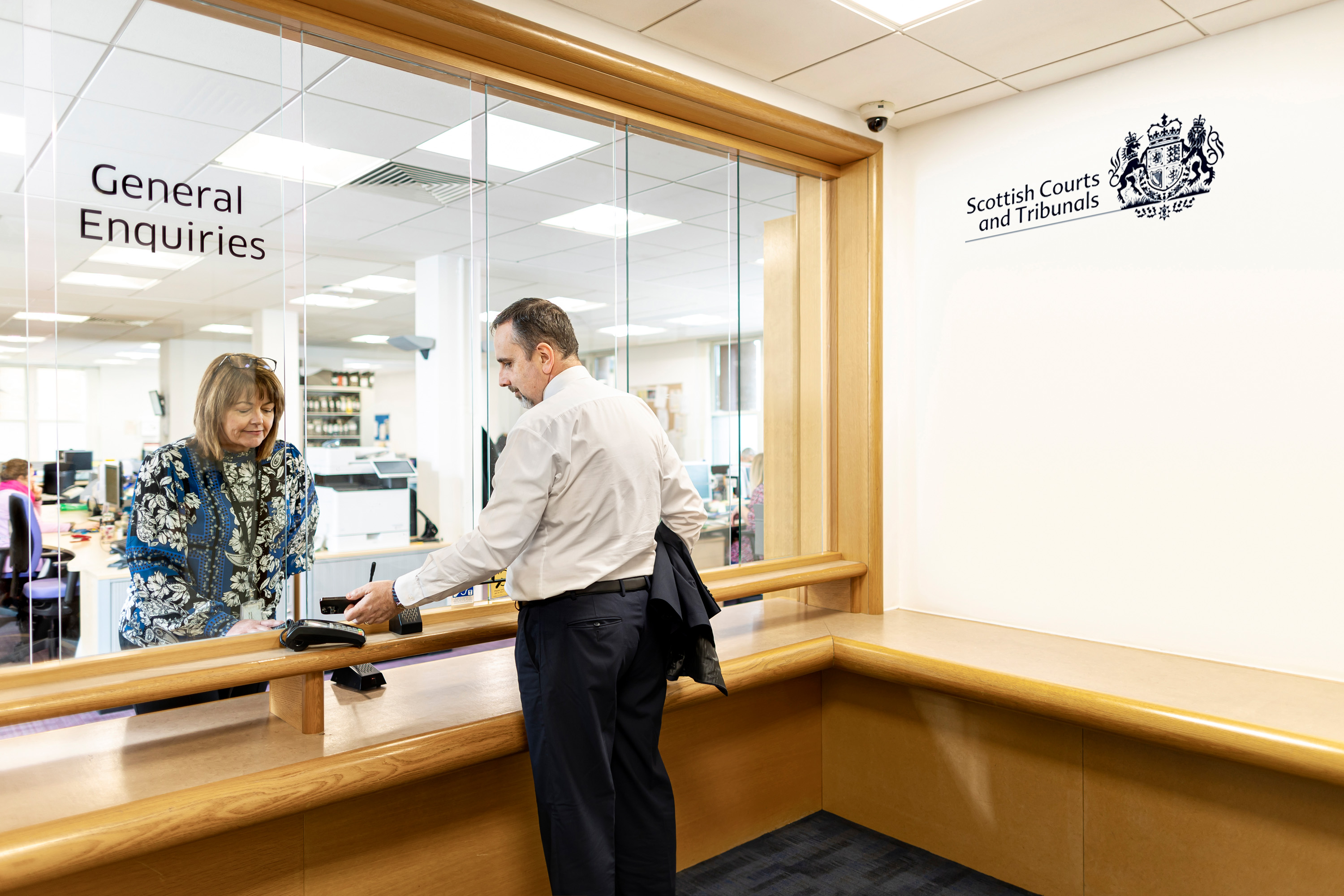 Staff taking payment at reception